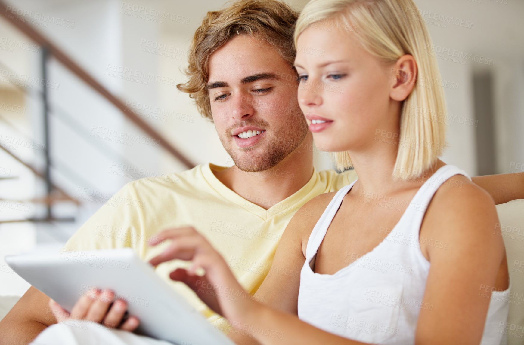 Buy stock photo Smile, tablet and young couple on sofa browsing on social media or internet at apartment. Happy, digital technology and man and woman from Australia relax and scroll on website in living room at home