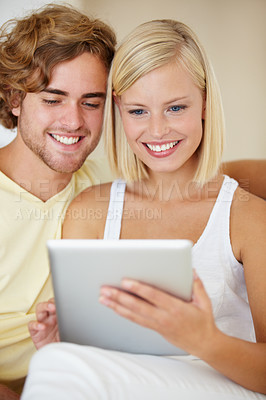Buy stock photo Smile, tablet and young couple on sofa browsing on social media or internet at apartment. Happy, digital technology and man and woman from Australia relax and scroll on website in living room at home