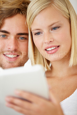 Buy stock photo Smile, tablet and young people on sofa browsing on social media or internet at apartment. Happy, digital technology and man and woman from Australia relax and scroll on website in living room at home