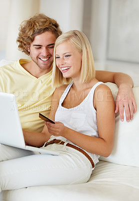 Buy stock photo Happy couple, credit card and laptop for home online shopping, loan and digital money on a sofa. Young woman and man on computer for internet banking, easy website payment or e commerce registration