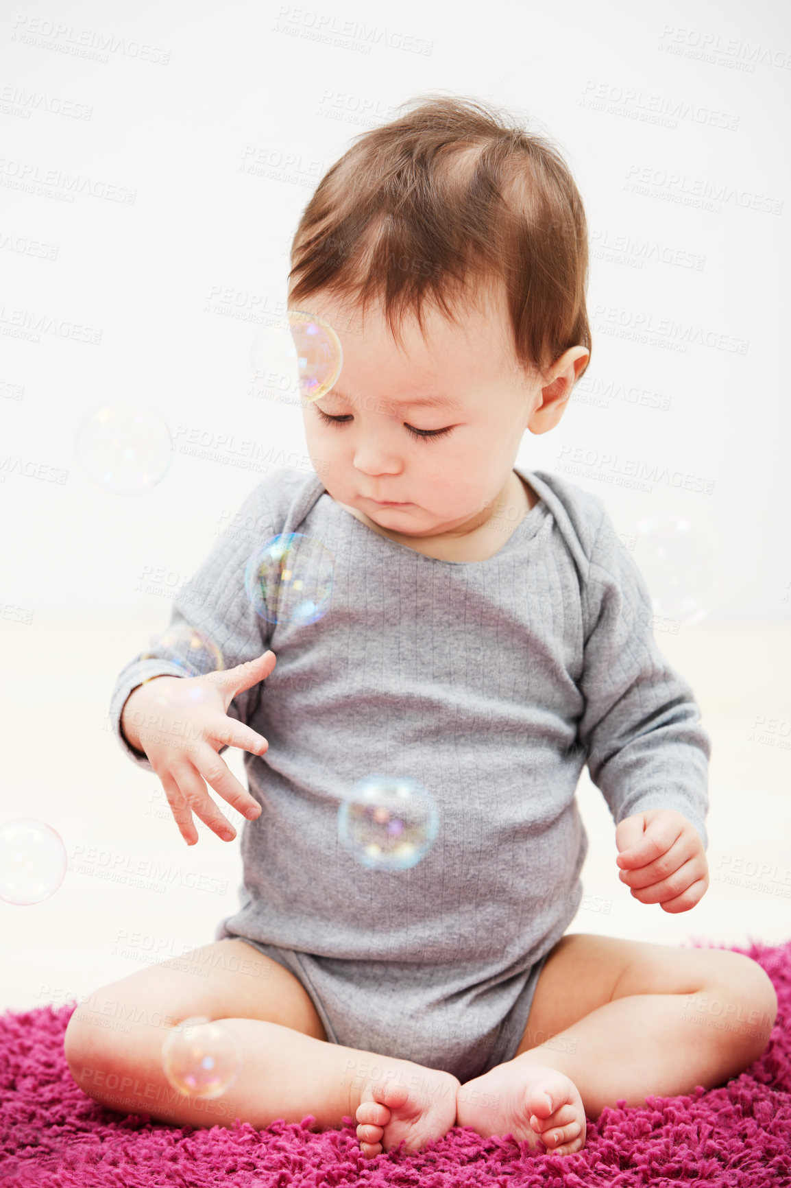 Buy stock photo Baby, bubbles and playing game in home for childhood development, curious wondering or education. Kid, growth toys and mockup space or learning progress for sensory, coordination or entertainment