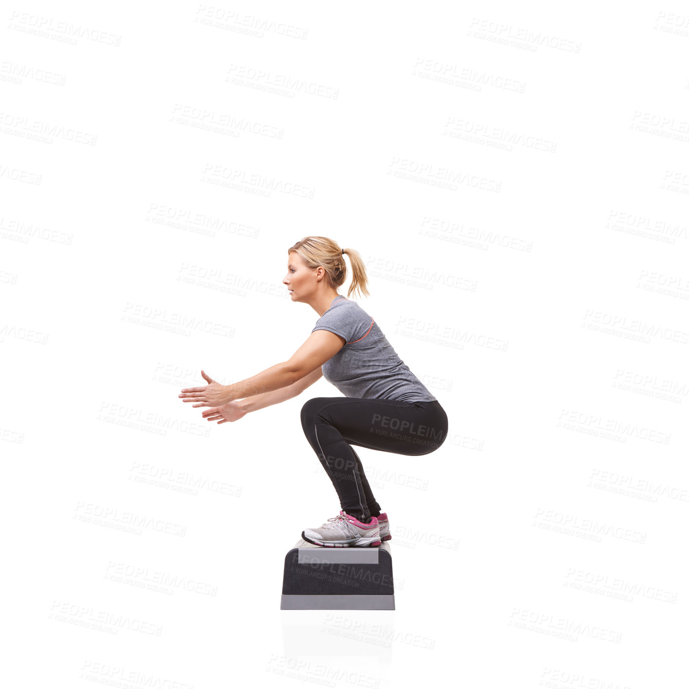 Buy stock photo A smiling young woman doing aerobics on an aerobic step against a white background