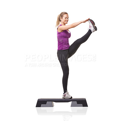 Buy stock photo A smiling young woman doing aerobic on an aerobics step against a white background