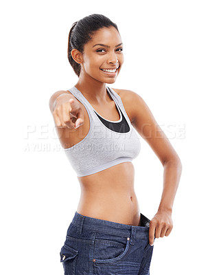 Buy stock photo Happy woman, portrait and pants pointing in weight loss, choice or decision against a white studio background. Attractive young female person or model smile for pick or choose in health and wellness