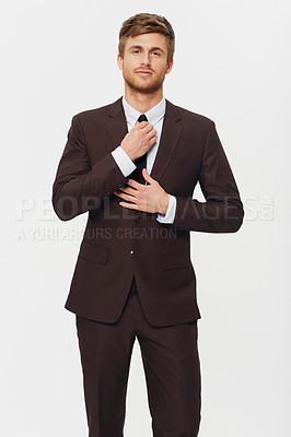 Buy stock photo Portrait, business and a man getting ready in a suit for his job opportunity in studio on white background. Corporate fashion, work and a confident young person dressing in a tie for a formal career