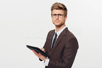 Buy stock photo Portrait, tablet and glasses with a business man in studio isolated on a white background for management. Corporate, technology and planning with a serious young employee in eyewear for research