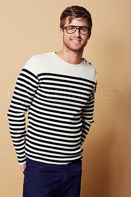 Buy stock photo Fashion, glasses and portrait of man in studio in trendy, stylish and casual clothes on beige background. Happy, attractive and person with stripe style for positive attitude, pride and confidence