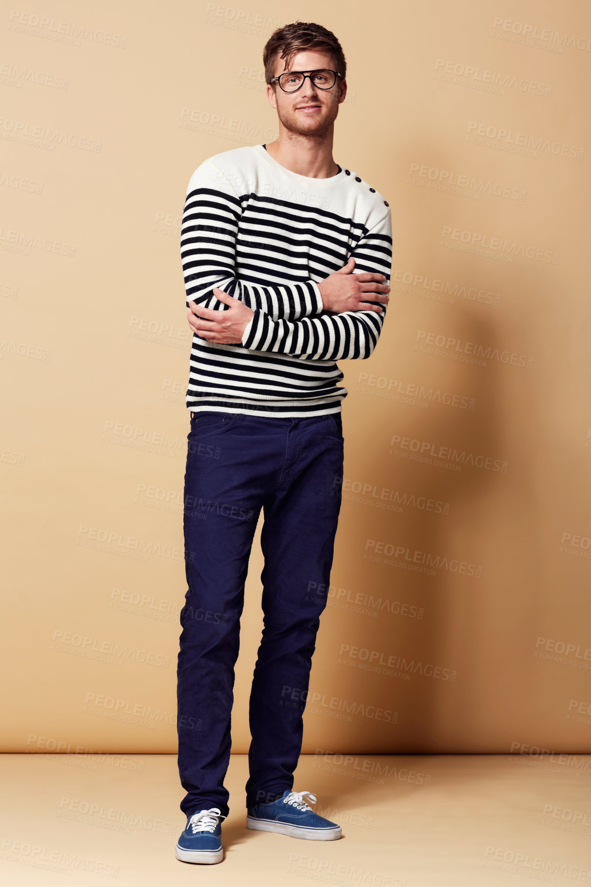 Buy stock photo Fashion, crossed arms and portrait of man on beige background in trendy, stylish and casual clothes. Happy, attractive and person with stripe style for positive attitude, pride and smile in studio