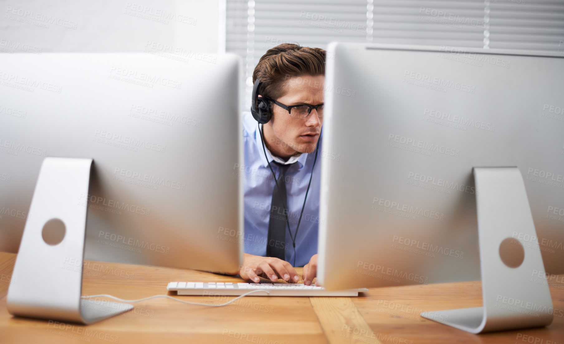 Buy stock photo Computer, office focus and business man typing, reading or working project, research report or statistics analysis. Information technology, cybersecurity and person listening to music while coding