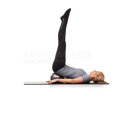 Buy stock photo Woman, exercise ball and back balance on yoga mat for workout performance, wellness or white background. Female person, gym equipment and pilates in studio for mockup space, challenge or stretching