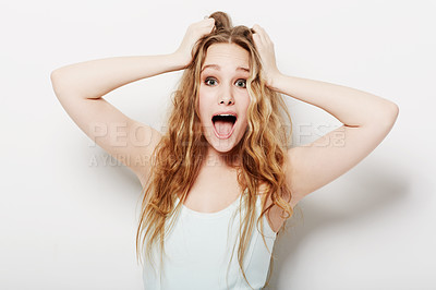 Buy stock photo Surprised young woman with her hands in her hair