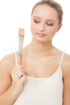 Buy stock photo A beautiful young woman looking at a applier covered with base dubiously