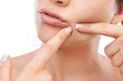Buy stock photo A cropped image of a woman squeezing a pimple