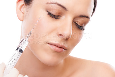 Buy stock photo Woman, face and needle for plastic surgery in studio for injection, chemical or product by white background. Girl patient, person and syringe for change, transformation or results for facial beauty