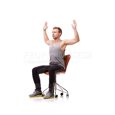 Buy stock photo A handsome young man wearing gym clothes and stretching while seated in an office chair against a white background