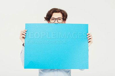 Buy stock photo A young man holding a blue placard up for your copyspace
