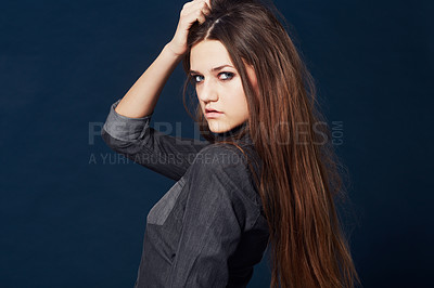 Buy stock photo Woman, portrait and attitude or confidence in studio or cool clothing, fashion and fierce by blue background. Female model person, mean and tough on face, beauty and trendy or edgy makeup in Sweden