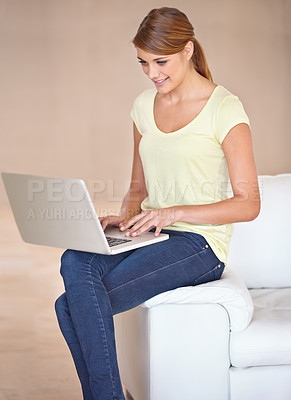 Buy stock photo Woman, smile and typing on laptop in home for reading blog post, social media and digital subscription for remote work. Freelancer at computer for online shopping, email and internet download on sofa
