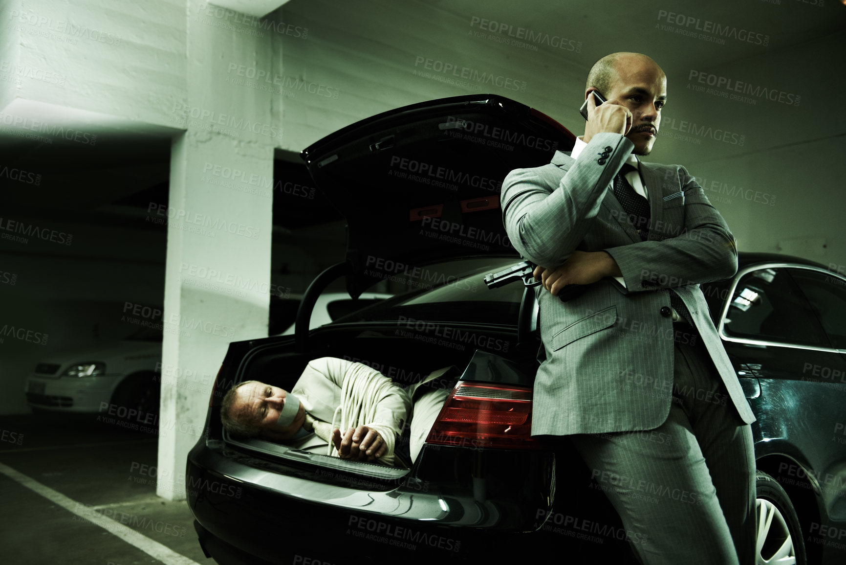 Buy stock photo Phone call, ransom and man with hostage in car for negotiation, kidnapping danger and crime. Mafia, gangster criminal and business person in boot for robbery, abduction and terrorism in parking lot