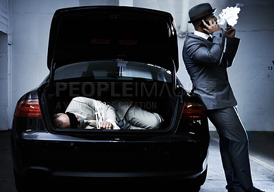 Buy stock photo Crime, car and man with hostage in trunk for negotiation, kidnapping ransom and phone call. Mafia, gangster criminal and businessman smoking in boot for abduction, danger and robbery in parking lot