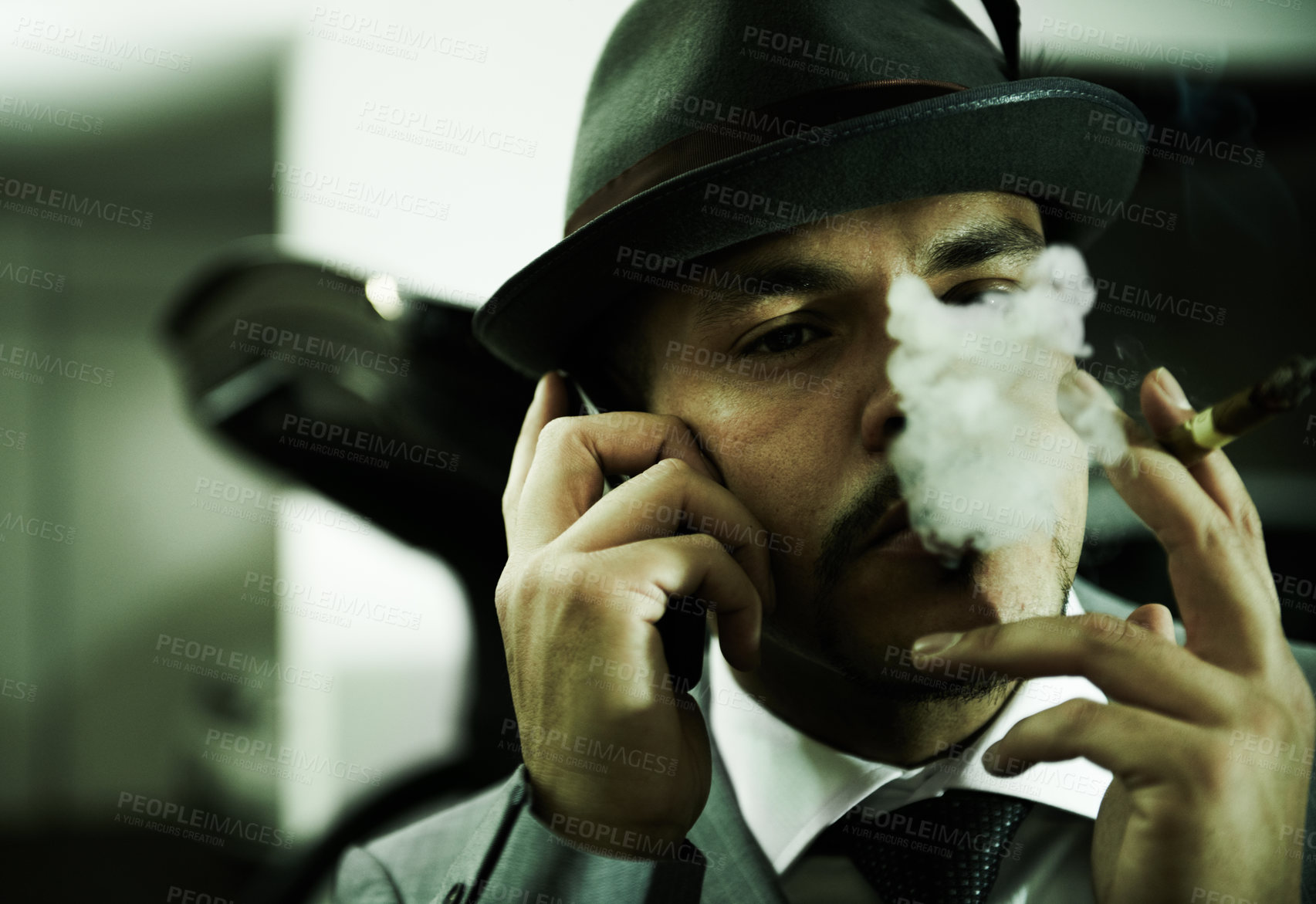 Buy stock photo Man, gangster and phone call while smoking or planning mafia, danger or ransom abduction. Male person, cigar and mobile device or hitman conversation for robbery violence, interrogation or terror