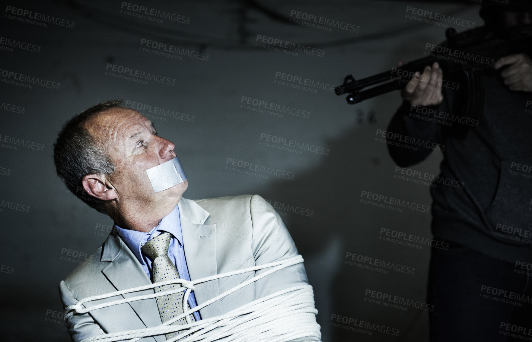 Buy stock photo Scared man, kidnap and hands with gun for crime, ransom and negotiation, interrogation or abduction risk at night. Criminal, senior person or corporate hostage with duct tape, and tied up in basement