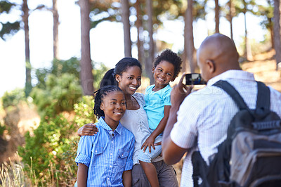 Buy stock photo Happy black family, photographer and nature for hiking, bonding or outdoor together for photo. African mother, children and father smile taking picture on phone for photography or adventure in nature