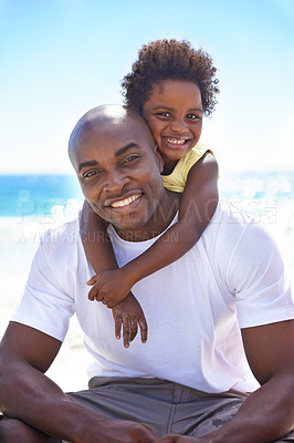 Buy stock photo A cute young african girl with her father on the beach