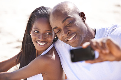 Buy stock photo Happy couple, selfie on beach and smile for vacation and married on holiday, outdoor and seaside. Young, african and love for commitment, bonding together and care for romantic relationship
