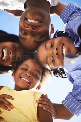 Buy stock photo Low view portrait of a happy african-american family spending the day at the beach together
