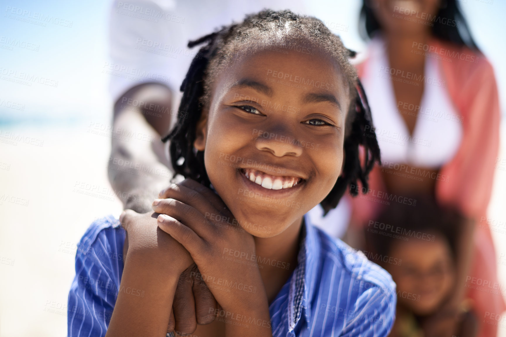 Buy stock photo Portrait, black boy and happiness on beach with family for adventure, holiday or vacation in summer. African kid, face and smile outdoor in nature for break, experience or bonding with relationship