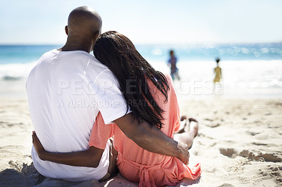 Buy stock photo Black family, relaxing on beach and hug with back, sand and love on summer vacation. African man and woman on holiday, sun tan and seaside outdoor with children, break and care by ocean in nature
