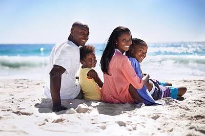 Buy stock photo A loving african-american family enjoying a day on the beach together