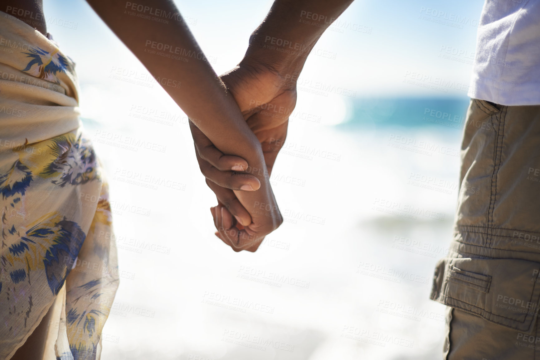 Buy stock photo Love, zoom and couple holding hands at a beach with love, respect and trust, bonding and commitment. Support, closeup and people in nature with kindness, security and solidarity on honeymoon vacation