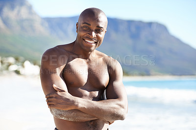 Buy stock photo Portrait of black man on beach, sun and smile in sunshine, arms crossed and outdoor island travel. Sea, mountain and happy guy on ocean holiday in summer with tropical adventure, confidence and face