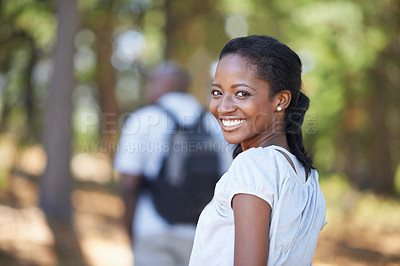 Buy stock photo Portrait, smile and black woman hiking in the forest together with her husband for travel, freedom or adventure. Face, nature or environment with a young hiker in the woods or wilderness for vacation