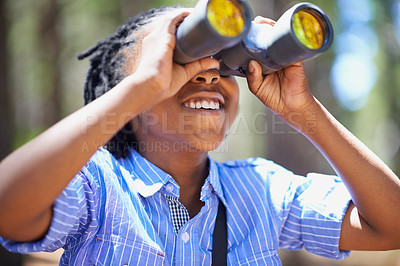 Buy stock photo Binocular, search and boy child in a forest for hiking, sightseeing or discovery. Lens, equipment and happy African kid in nature for adventure, learning or seeing, explore or  watching while camping