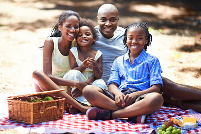 Buy stock photo Portrait, happy and black family with forest picnic, fun or bonding in nature together. Love, food and children with parents in park for fruit, nutrition or healthy snacks while playing in the woods