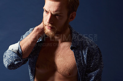 Buy stock photo Fashion, body or model with muscle in studio on a blue background wearing an open unbuttoned shirt. Thinking, chest or handsome male person posing on color wall for masculine style, health or fitness