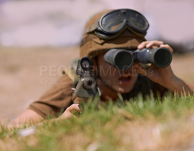 Buy stock photo A young soldier looking through his binoculars