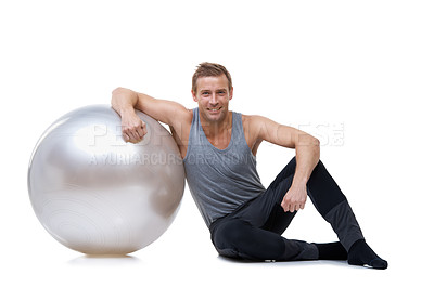 Buy stock photo Relax, fitness and medicine ball with portrait of man in studio for exercise, yoga and aerobics workout. Health, gym and pilates with person on white background for wellness, commitment and vitality