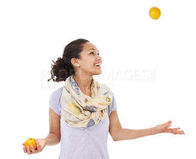 Buy stock photo Young woman smiling while juggling some fresh oranges