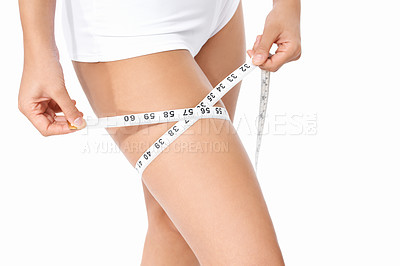Buy stock photo Woman, legs and tape measure for weight loss, slim body or health and wellness on a white studio background. Closeup of female person or model measuring thigh in diet, fitness or healthcare on mockup