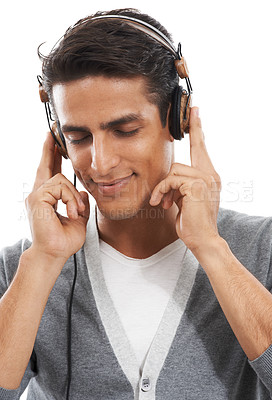 Buy stock photo Happy, man and headphones in studio for calm playlist, audio subscription and streaming multimedia on white background. Model listening to peaceful music, hearing sound and relax for podcast on radio