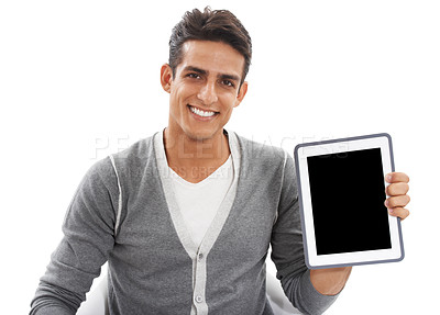 Buy stock photo Portrait of a handsome young man smiling and holding a ipad against a white background