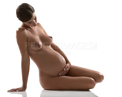 Buy stock photo Attractive pregnant woman sitting naked in a studio