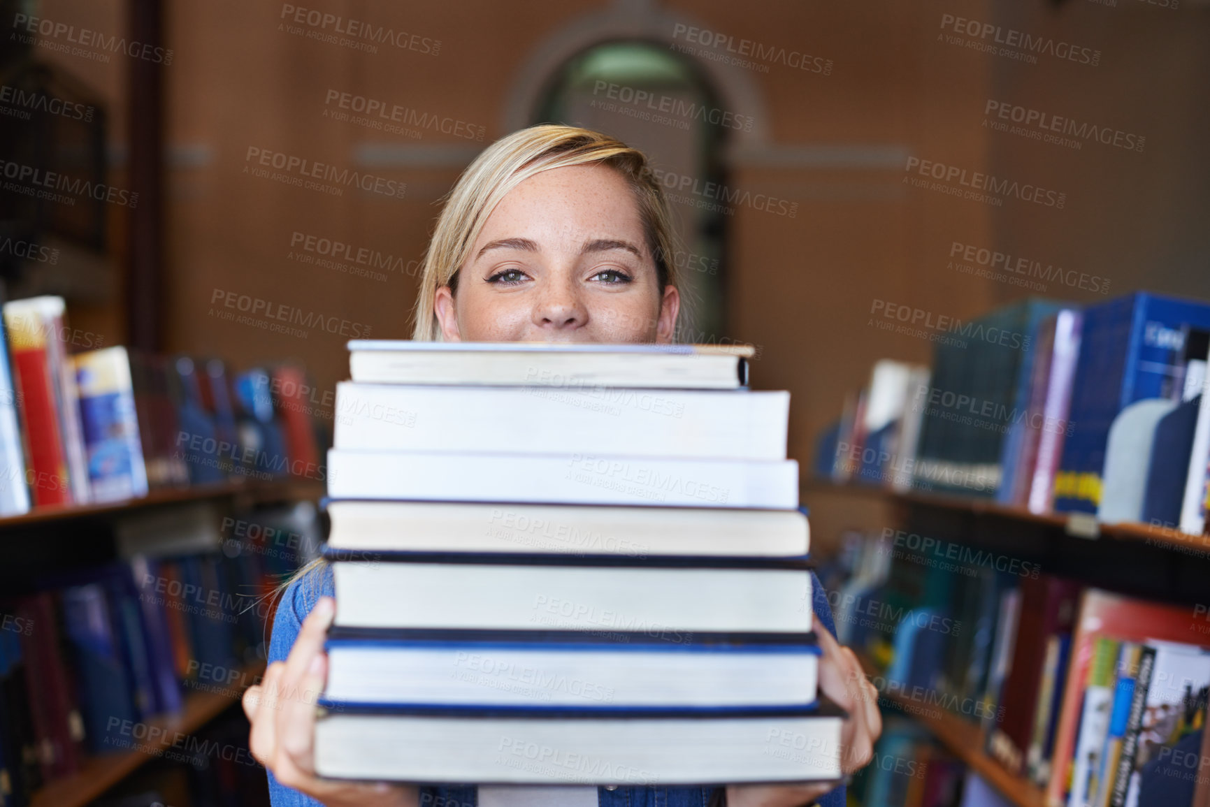 Buy stock photo Portrait of a beautiful young student holding a large pile of textbooks