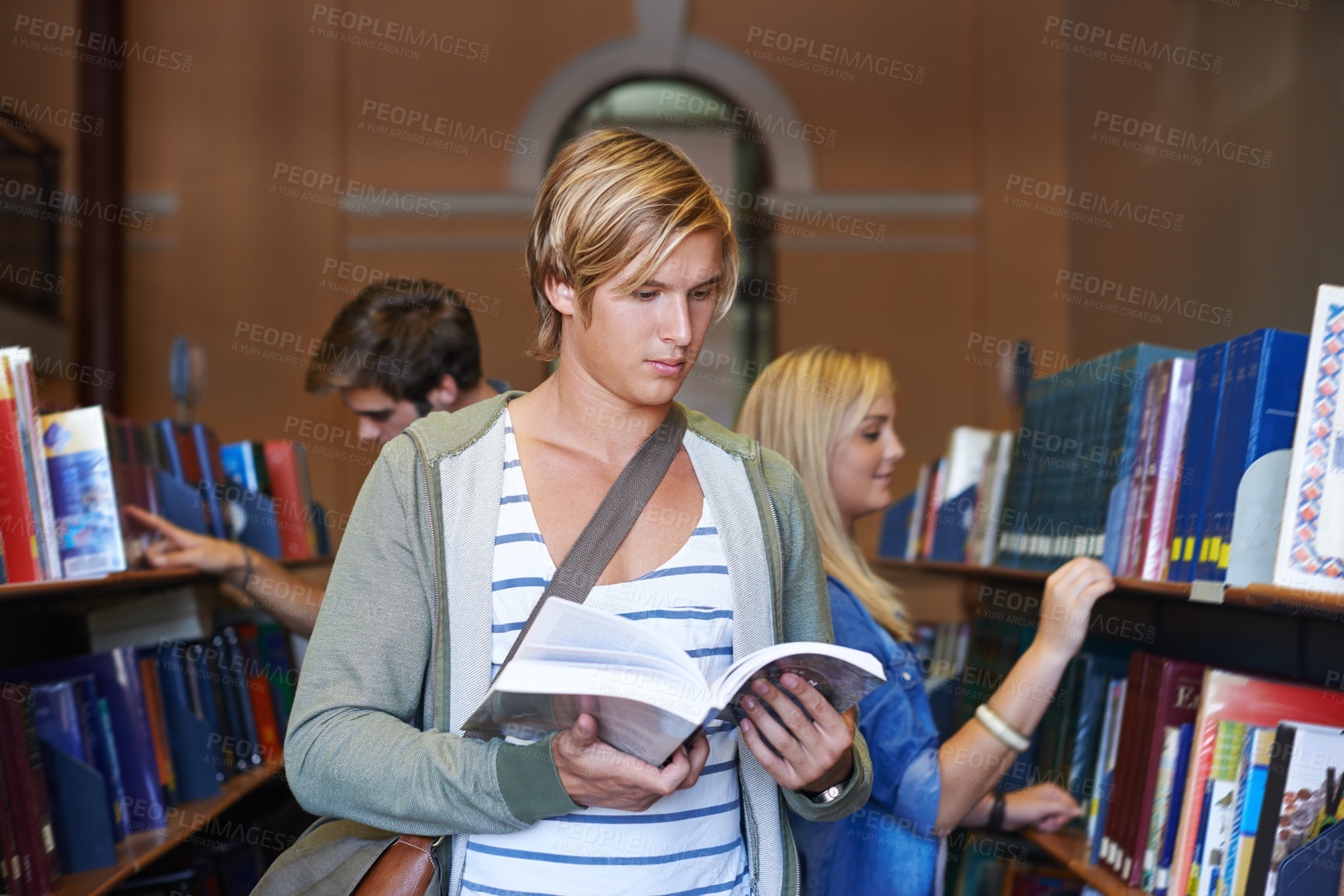Buy stock photo Reading book, knowledge or man in library at university, college or school campus for future education. Bookshelf, focus or male student with scholarship studying research or learning information 