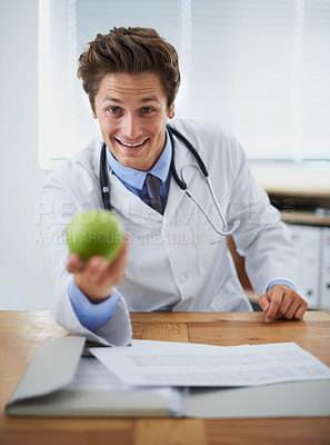 Buy stock photo Happy, apple and portrait of man doctor with stethoscope for positive, good and confident attitude. Smile, pride and young male healthcare worker with fruit in medical office of hospital or clinic.