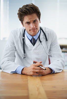 Buy stock photo Serious, confused and portrait of doctor in his office for medical consultation at hospital. Doubt, thinking and professional young male healthcare worker with stethoscope by desk at medicare clinic.